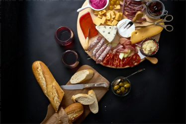 antipasti-board-with-different-cheese-and-meat-snacks-with-red-wine-and-baguette-on-wooden-board