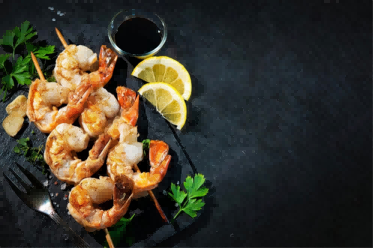 grilled-shrimp-skewers-served-with-soy-sauce-garlic-fresh-parsley-and-lemon-on-black-plate